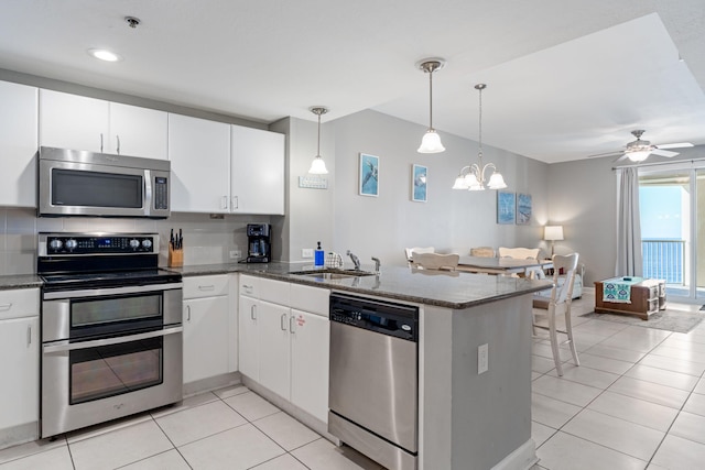 kitchen with white cabinetry, kitchen peninsula, hanging light fixtures, and stainless steel appliances