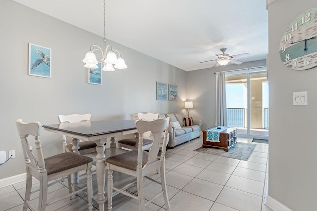 dining area featuring ceiling fan with notable chandelier and light tile patterned floors