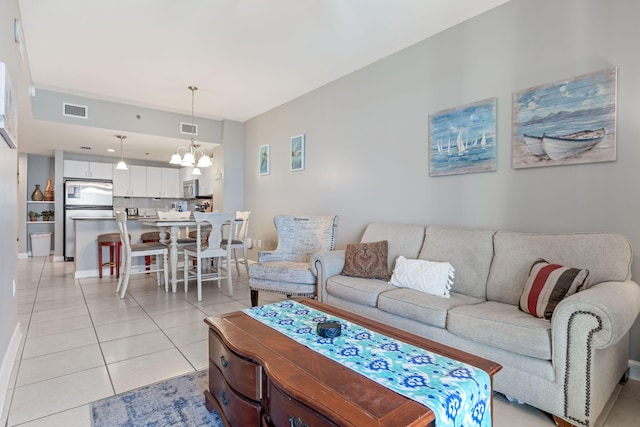 living room with a notable chandelier and light tile patterned floors