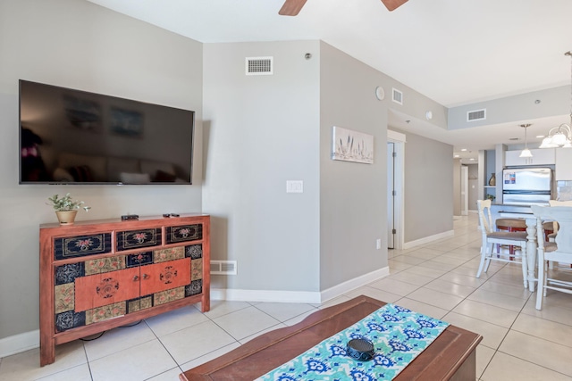 tiled living room with ceiling fan