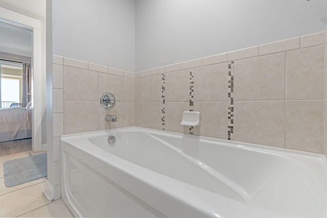 bathroom featuring tiled tub and tile patterned floors