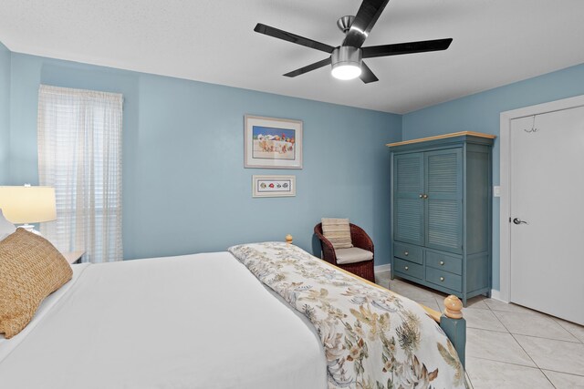 bedroom with ceiling fan and light tile patterned floors