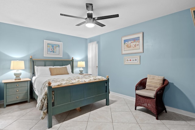 bedroom featuring ceiling fan, light tile patterned flooring, and a textured ceiling