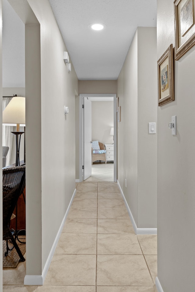 hall featuring light tile patterned floors