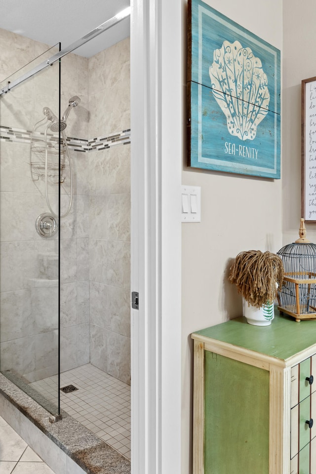 bathroom with tile patterned floors and an enclosed shower