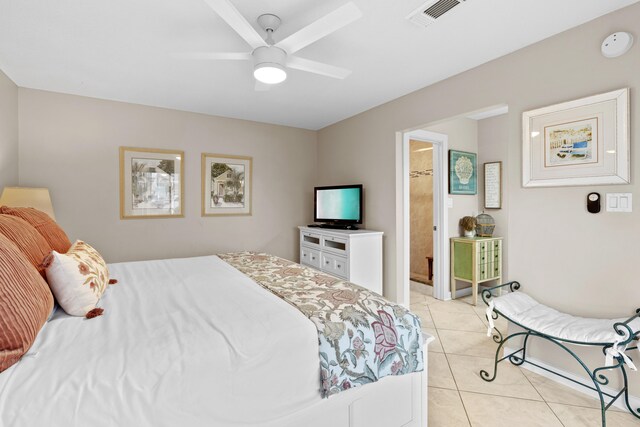 tiled bedroom with ceiling fan and ensuite bathroom