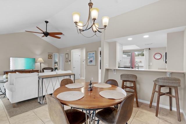 tiled dining room featuring ceiling fan with notable chandelier and vaulted ceiling