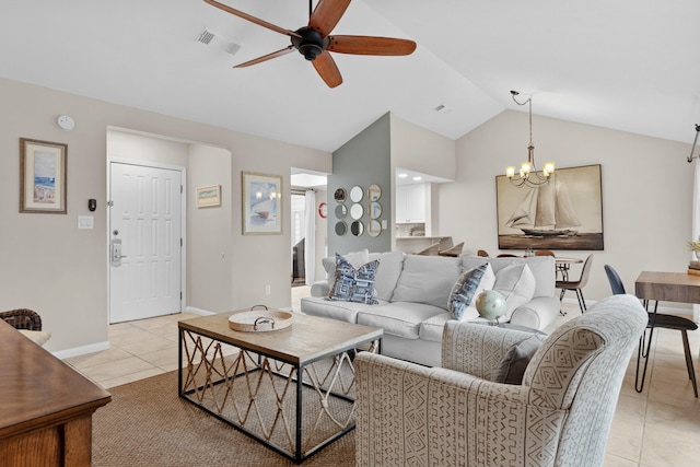 living room featuring ceiling fan with notable chandelier, light tile patterned floors, and vaulted ceiling