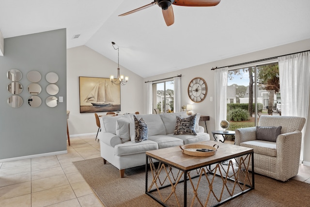 living room with plenty of natural light, light tile patterned flooring, ceiling fan with notable chandelier, and vaulted ceiling