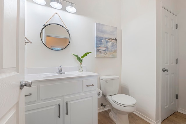 bathroom featuring hardwood / wood-style floors, vanity, and toilet