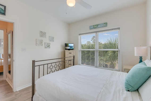 bedroom with light hardwood / wood-style floors and ceiling fan