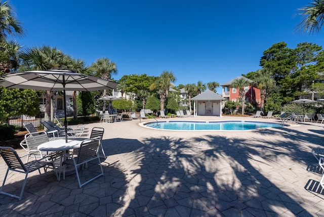 view of pool featuring an outdoor structure and a patio