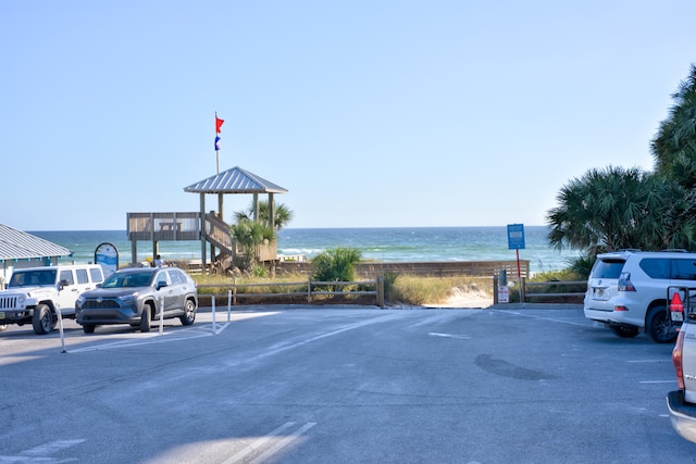 view of parking / parking lot featuring a water view