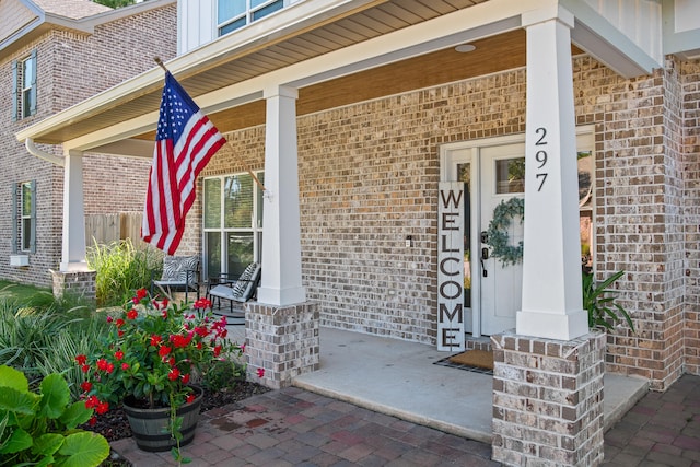 view of exterior entry with covered porch