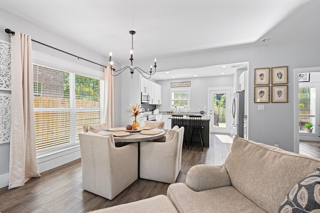 dining space featuring a notable chandelier, dark hardwood / wood-style floors, and a wealth of natural light