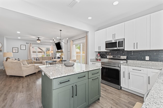 kitchen featuring appliances with stainless steel finishes, light hardwood / wood-style flooring, white cabinetry, and green cabinetry