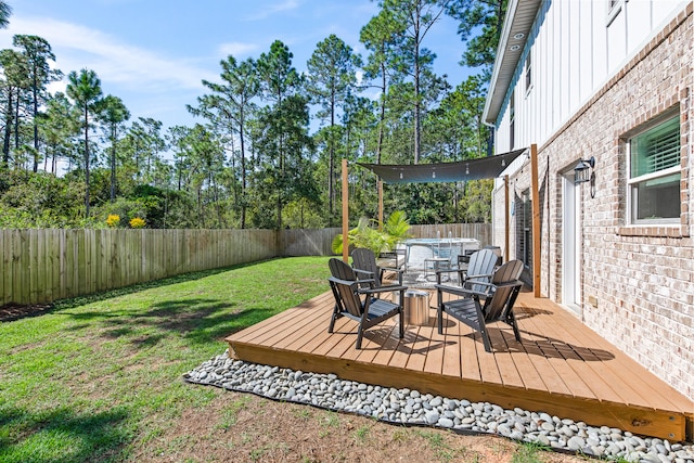 wooden terrace featuring a yard