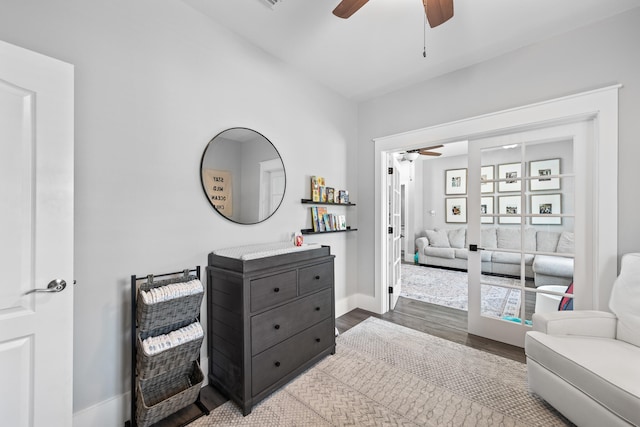 sitting room with hardwood / wood-style flooring and ceiling fan