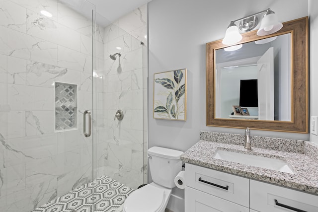 bathroom with vanity, toilet, and an enclosed shower