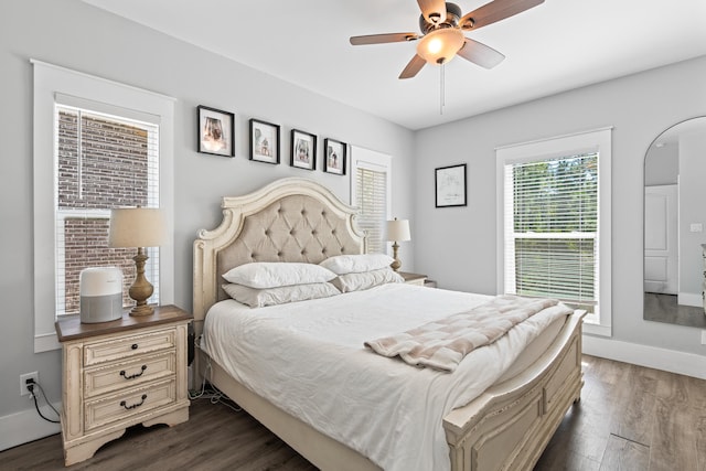 bedroom with dark hardwood / wood-style flooring and ceiling fan