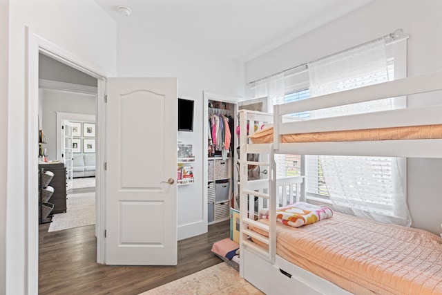 bedroom featuring dark hardwood / wood-style floors and a closet