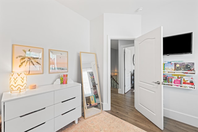 bedroom with dark hardwood / wood-style floors