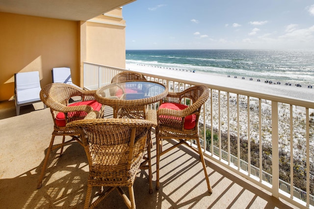 balcony featuring a water view and a view of the beach