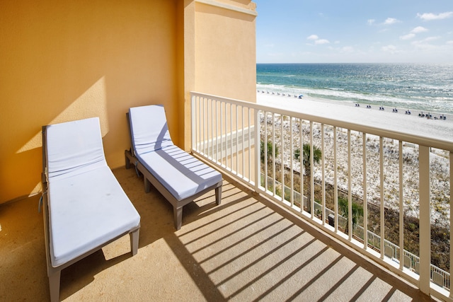 balcony featuring a water view and a view of the beach