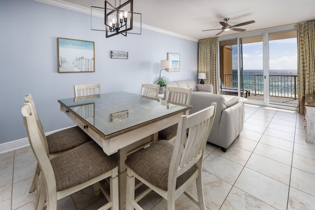 tiled dining room featuring a water view, crown molding, and ceiling fan with notable chandelier