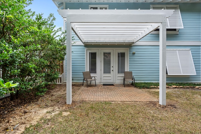 back of property featuring a patio area, a lawn, and french doors