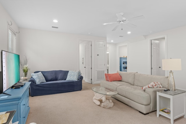 living room featuring light carpet and ceiling fan