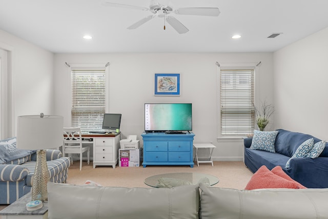 living room featuring carpet floors and ceiling fan