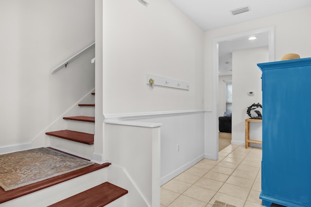 stairway featuring tile patterned flooring