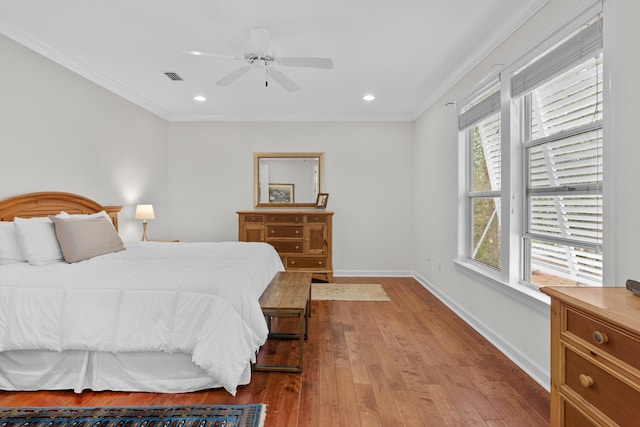 bedroom featuring ornamental molding, light hardwood / wood-style flooring, and ceiling fan