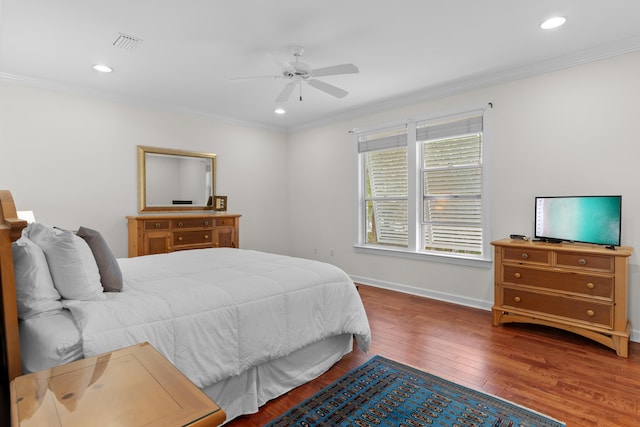 bedroom featuring hardwood / wood-style flooring, ceiling fan, and crown molding