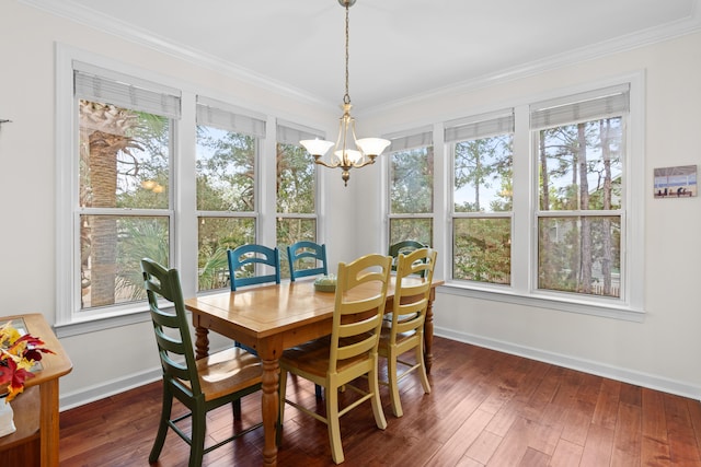 dining space with ornamental molding, an inviting chandelier, dark hardwood / wood-style floors, and plenty of natural light