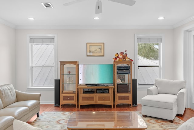 living room featuring ceiling fan, wood-type flooring, and crown molding