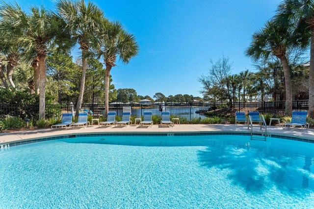 view of swimming pool with a water view