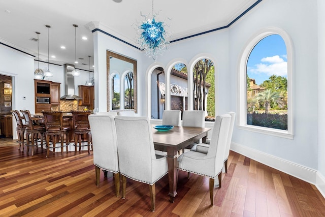 dining space featuring ornamental molding and dark wood-type flooring