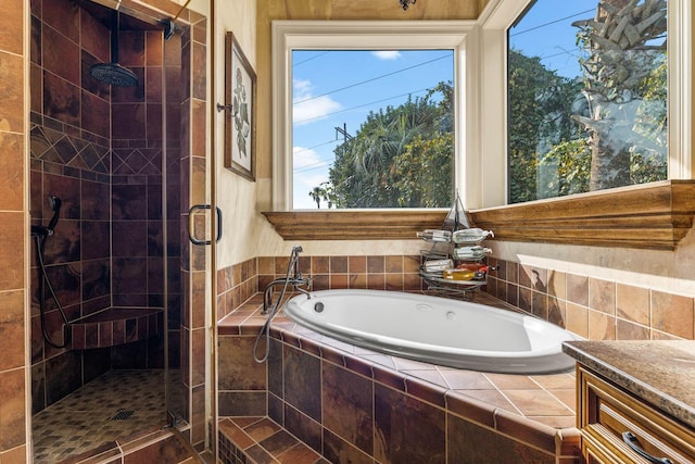 bathroom with vanity and shower with separate bathtub