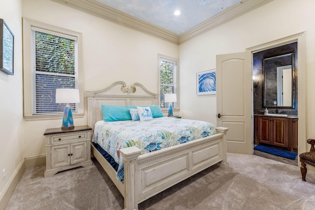 bedroom featuring connected bathroom, crown molding, light colored carpet, and sink