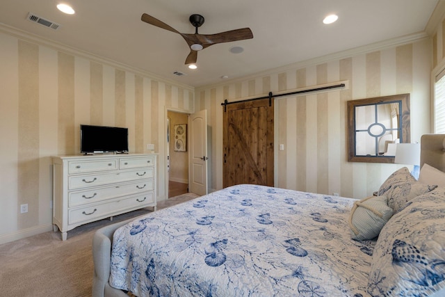 carpeted bedroom featuring crown molding, a barn door, and ceiling fan