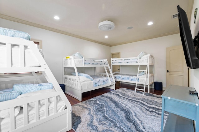 bedroom featuring crown molding and dark hardwood / wood-style flooring