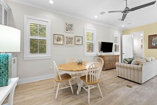 dining room with crown molding, light wood-type flooring, and ceiling fan