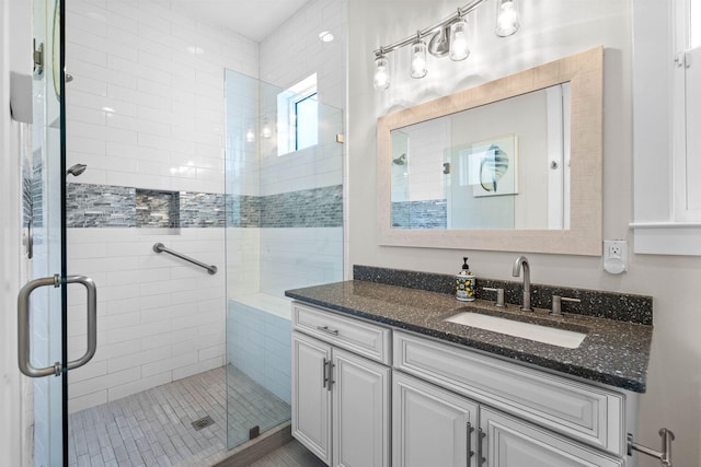 bathroom featuring vanity and an enclosed shower