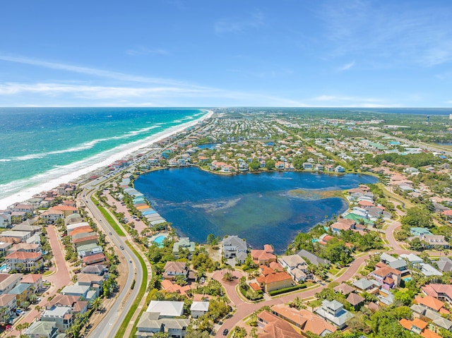 bird's eye view with a water view and a beach view