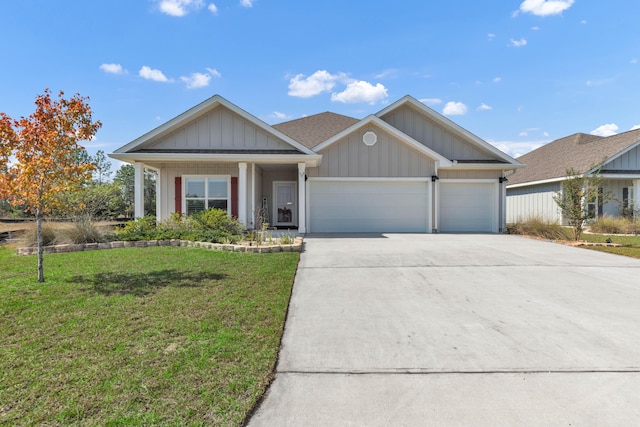 view of front of home with a front yard and a garage