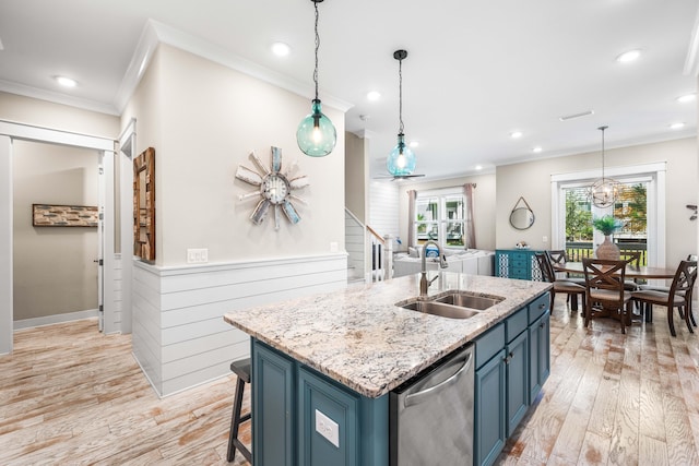 kitchen with an island with sink, light hardwood / wood-style flooring, dishwasher, sink, and blue cabinets