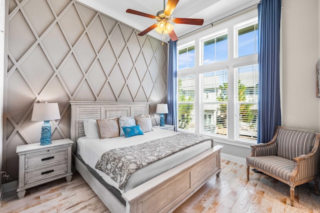 bedroom with light hardwood / wood-style flooring and ceiling fan