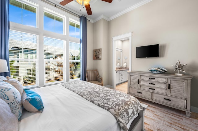 bedroom with light hardwood / wood-style floors, ornamental molding, connected bathroom, and ceiling fan